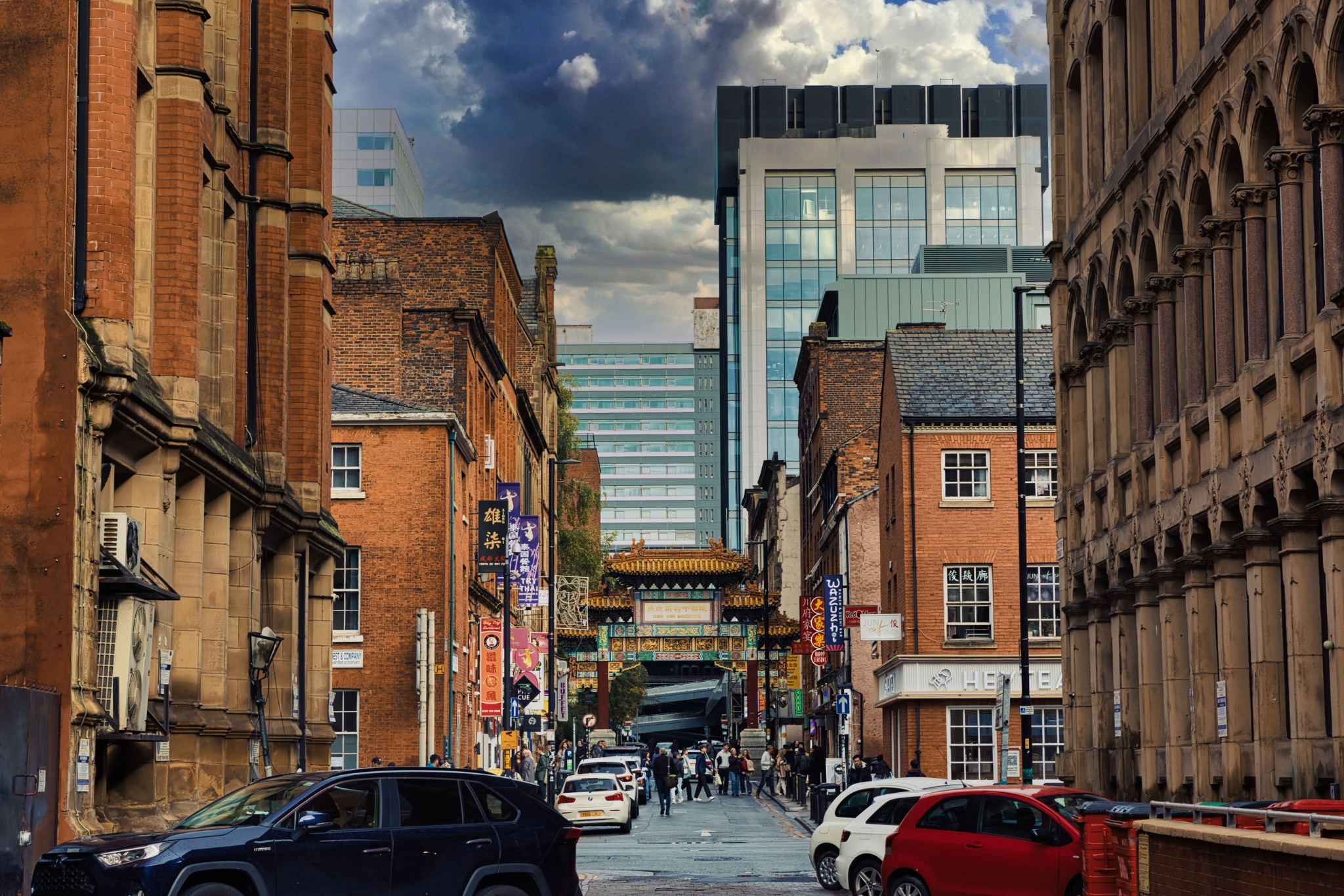 Street View with Chinese Archway and Brick Buildings in Manchester, UK.